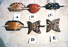 Stick barrettes in assorted designs.  Butterfly, knot, oval